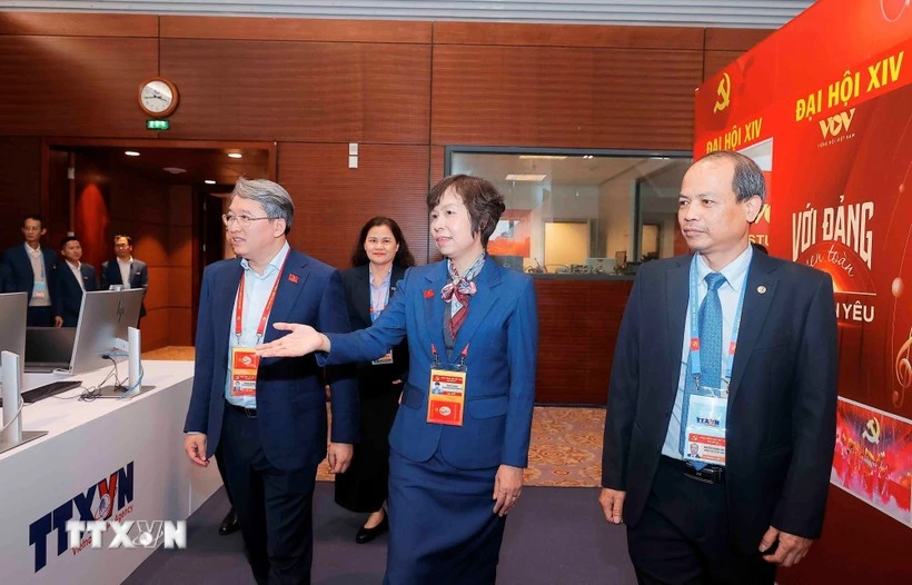 Member of the Party Central Committee and Minister of Justice Nguyen Hai Ninh (L) visits the working area of the Vietnam News Agency at the press centre of the 14th National Party Congress. (Photo: VNA)