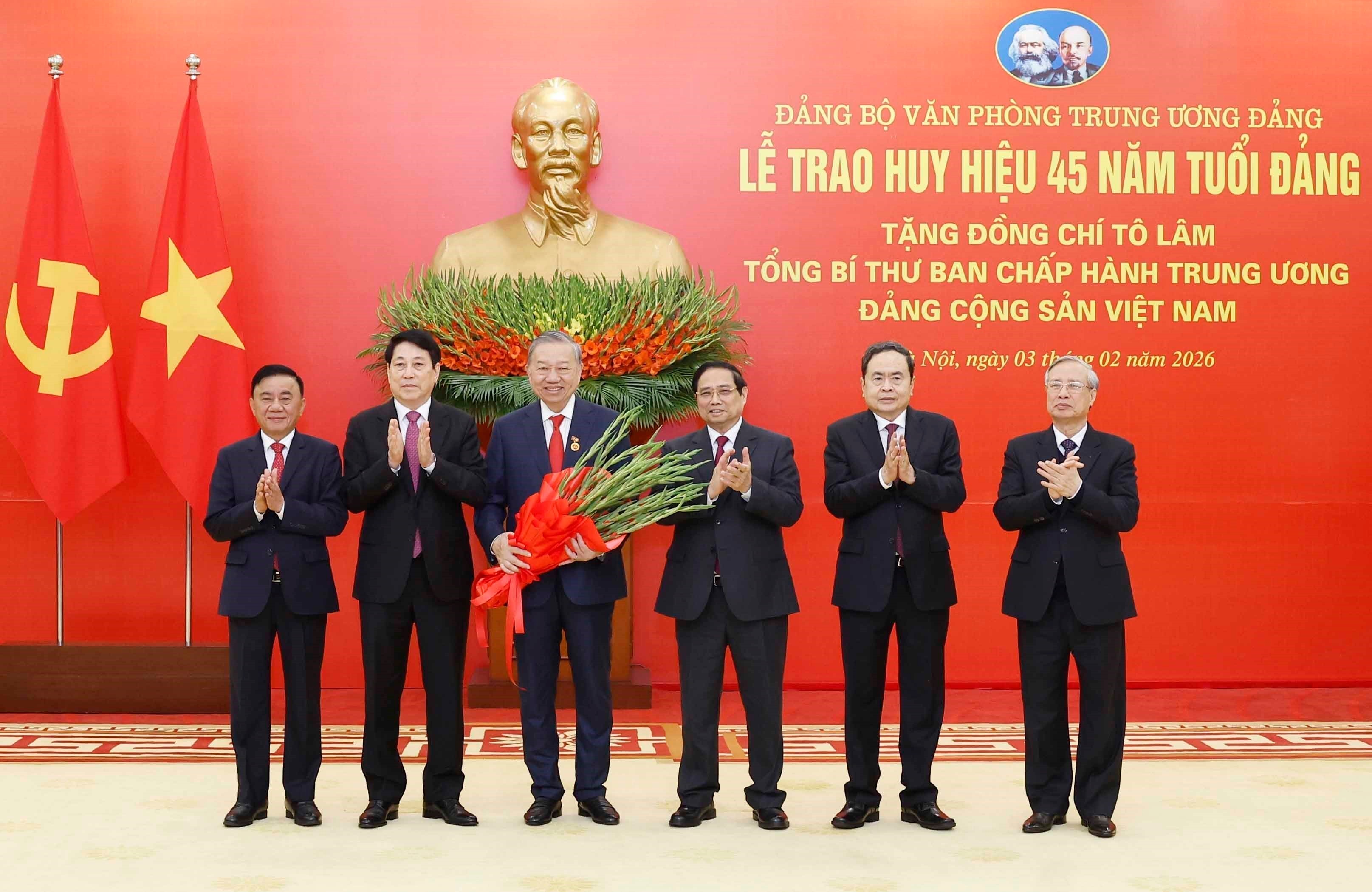 Party General Secretary To Lam (third, left) is awarded the 45-year Party membership badge. (Photo: VNA)