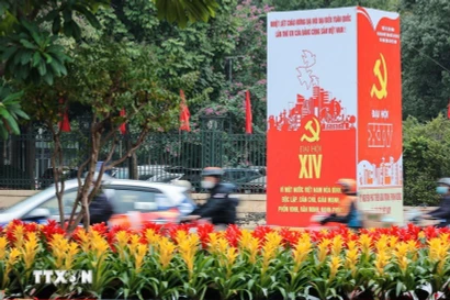 The slogans and emblems of the 14th National Congress of the Communist Party of Vietnam stand out amidst the traffic on the streets of Hanoi. (Photo: VNA)