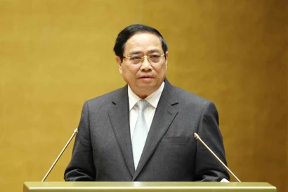 Prime Minister Pham Minh Chinh presents the action plan for implementing the Resolution of the 14th National Party Congress at the conference on February 7. (Photo: VNA)