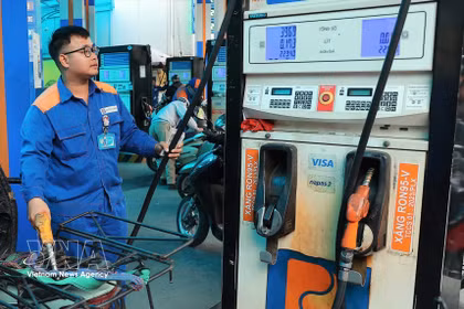 A worker refuels a motorbike at a Petrolimex station. (Photo: VNA)