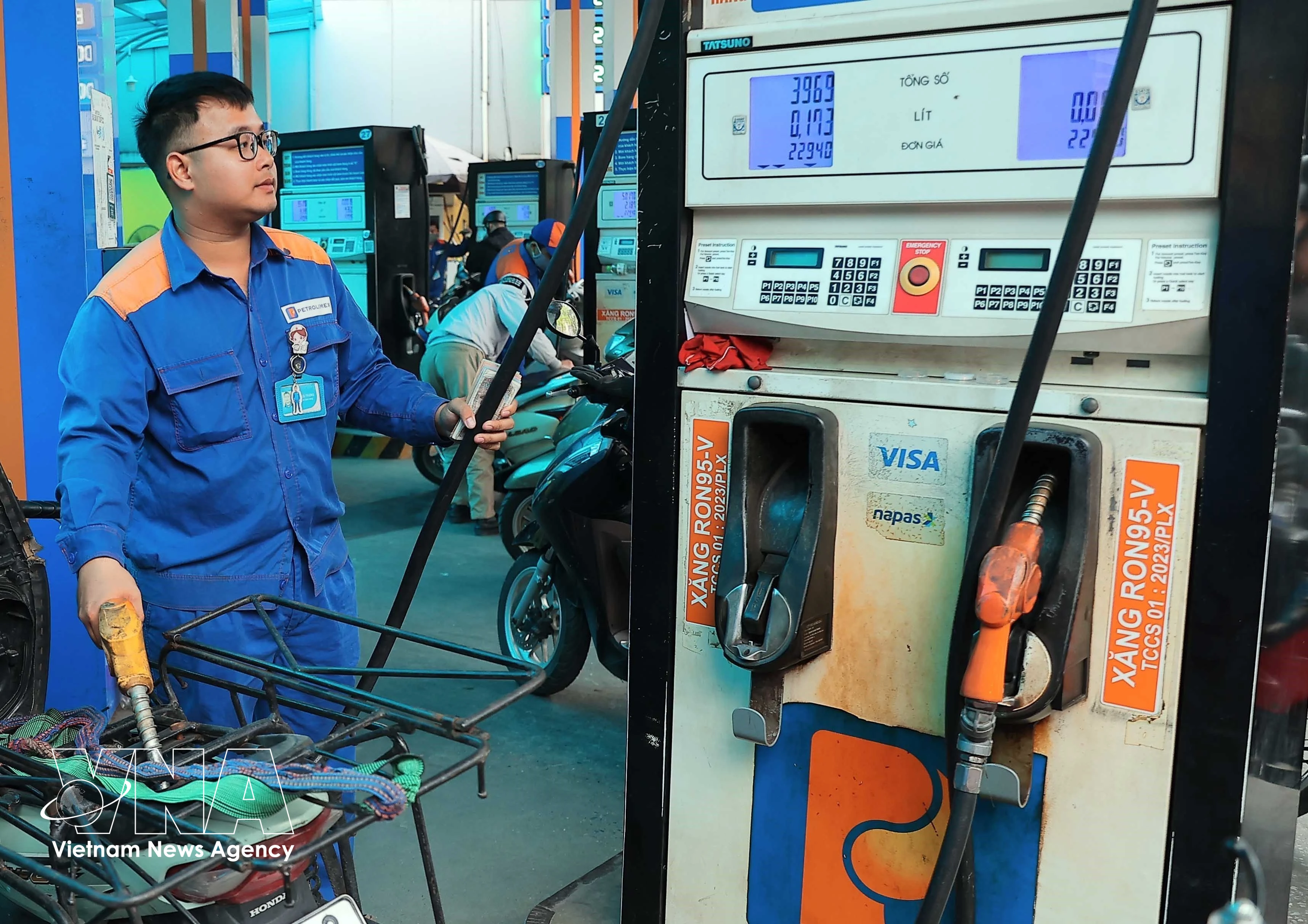 A worker refuels a motorbike at a Petrolimex station. (Photo: VNA)