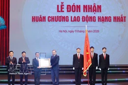 Party General Secretary To Lam presents Nhan Dan newspaper with the first-class Labour Order on March 11. (Photo: VNA)
