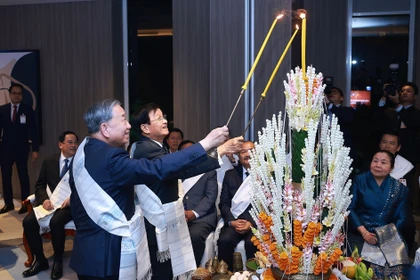 Top Vietnamese leaders attend traditional Lao wrist-tying ceremony