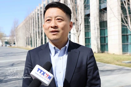 Professor Qu Qiang, commentator for the China Global Television Network (CGTN) and lecturer at the Minzu University of China, in an interview with the Vietnam News Agency. (Photo: VNA)