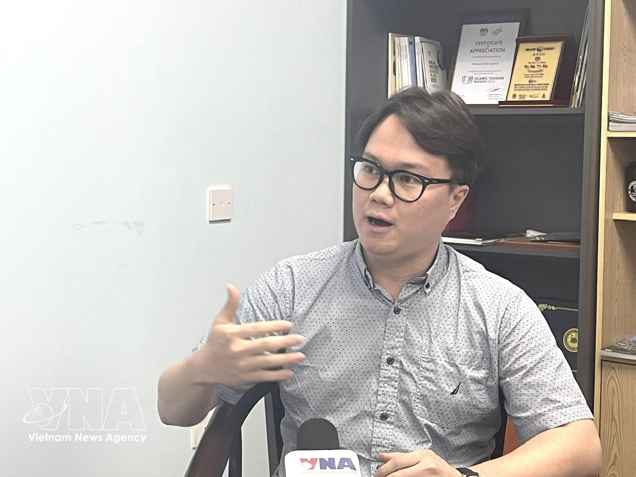Malaysia-based researcher Enzo Sim Hong Jun grants an interview to the Vietnam News Agency. (Photo: VNA)