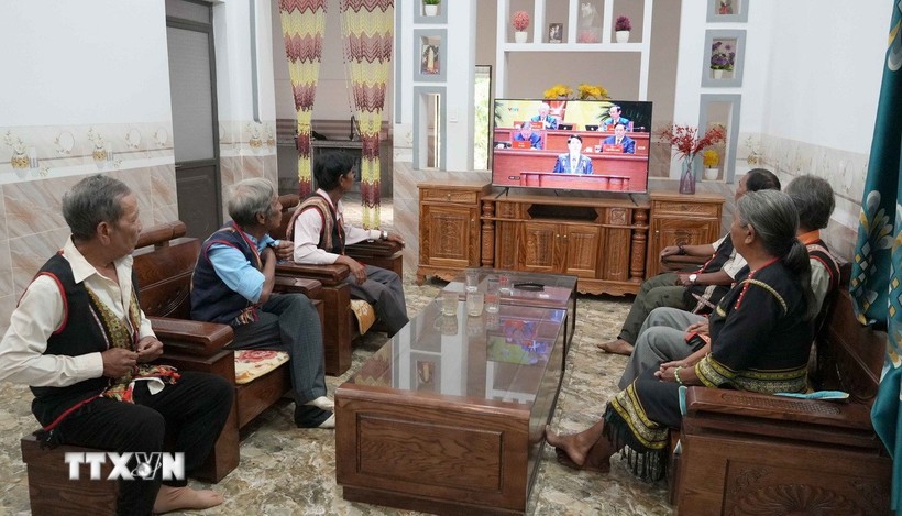 Village elders, respected figures, and villagers of Plei Jo Drop hamlet, Ia Chim commune, Quang Ngai province, watch the opening session of the 14th National Party Congress. (Photo: VNA)