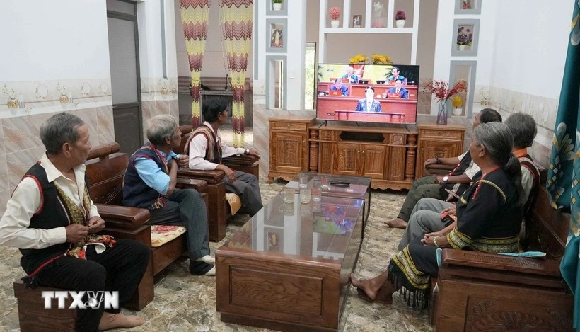 Village elders, respected figures, and villagers of Plei Jo Drop hamlet, Ia Chim commune, Quang Ngai province, watch the opening session of the 14th National Party Congress. (Photo: VNA)